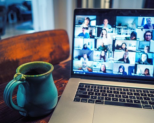 Computer in a person's home displaying a company zoom meeting